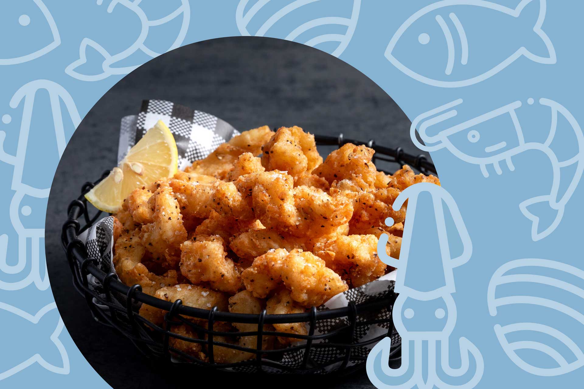 Basket of golden fried calamari with lemon wedge served on black and white check paper. Image used in article about Australia’s Country of Origin Labelling (CoOL) law changes for seafood and foodservice businesses.