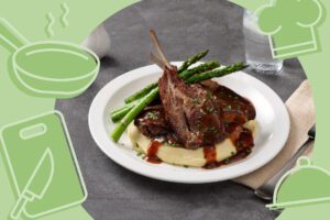Sous-vide lamb shoulder rack served with creamy mashed potatoes, grilled asparagus and rich gravy, garnished with herbs — a premium Naturalaz lamb dish for Australian chefs.
