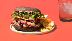 The beef wellington bagel. A loaded sesame seed bagel, filled with sliced rare roast beef, jamon, mushroom duxelles and beef stroganoff spice mix.