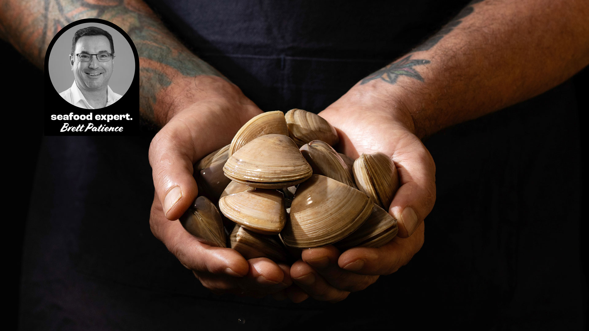 Tattooed hands holding a large handful of fresh Cloudy Bay clams, with a photo inset of seafood expert Brett Patience.