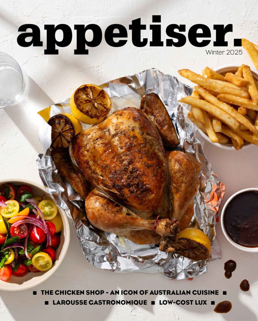 Cover of appetiser Winter 2025 featuring a roast chicken with charred lemons, golden chips, colourful salad, and a side of gravy.